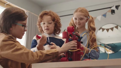 Three Classmates Constructing Robot during Lesson Video stock 153465436