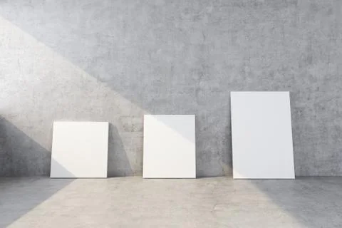 Three clean canvases of different sizes stand near the concrete wall Stock Illustration