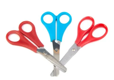 Three closed blue and red scissors for kids on a white background Stock Photos