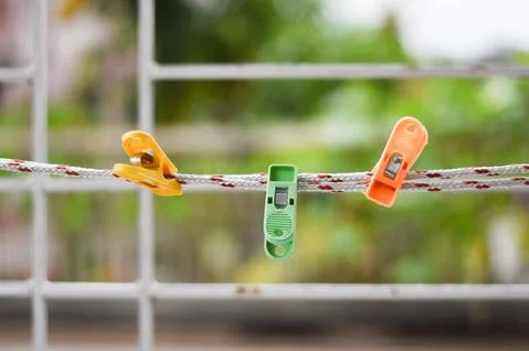 Three Clothes-pins hanging on a string Foto stock