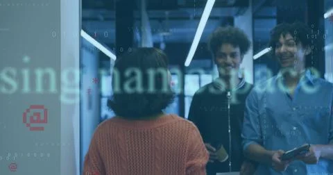 Three co-workers exchanging code in office corridor, with smartphone, tablet, Foto stock