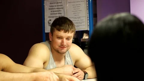 Three coaches are chatting at the bar in the fitness club Stock Footage 75383394