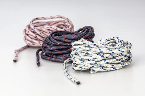 Three Coiled Braided Nylon Ropes in White, Black, and Gray with Color Accents Stock Photos
