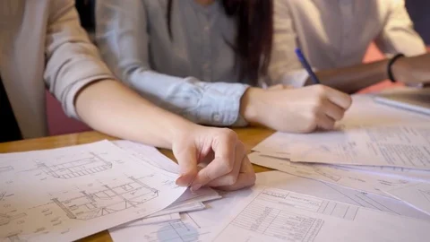 Three colleague prepares the documents for important business negotiations. Stock Footage 82850267