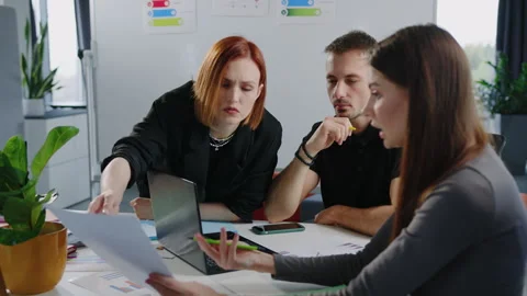Three colleagues are actively discussing a new startup in a stylish office Stock Footage 257423500