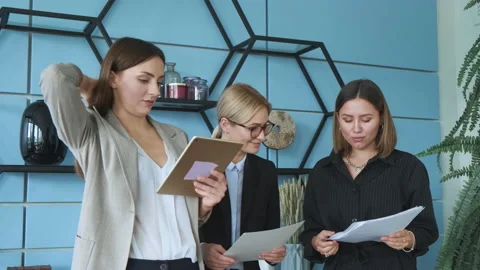 Three colleagues communicate and make a presentation. Stock Footage 130868593