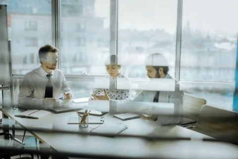 Three colleagues developing new concepts in the office Stock Photos