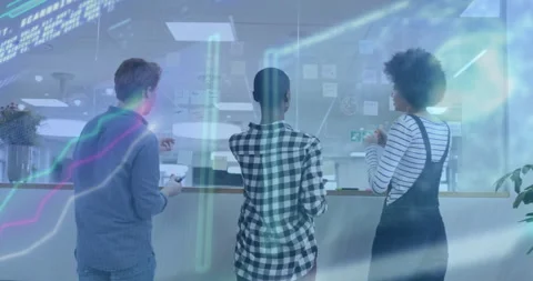 Three colleagues placing sticky note on glass board and building project plan Stockbeeldmateriaal 311141779