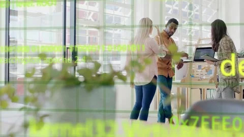Three colleagues responding to fading code overlay, pointing at laptop, Stock Footage 333494471