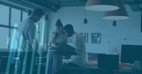 Three colleagues reviewing documents at high table in modern office, with tablet Stock Photos
