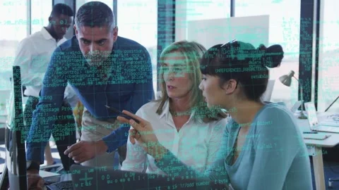Three colleagues working around laptop, woman pointing pen activating green code Stock Footage 333078377