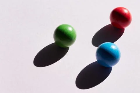 Three colored balls on a light background with hard shadows. abstract backgro 写真素材
