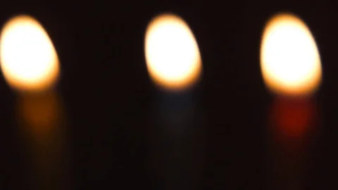 Three colored candles burns in the dark Vidéo 82371520