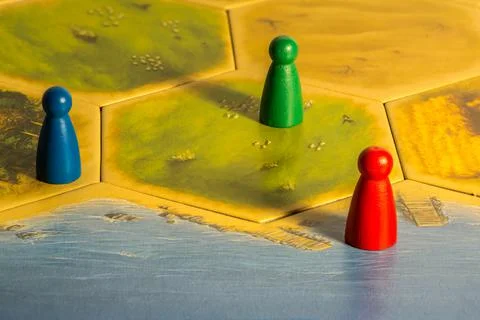 Three colored chips on yellow game board Stock Photos