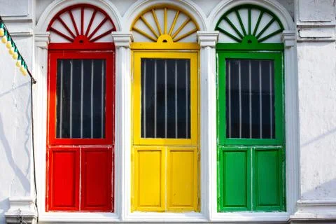 Three colored doors or windows outside on the facade of an ancient house in P Stock Photos