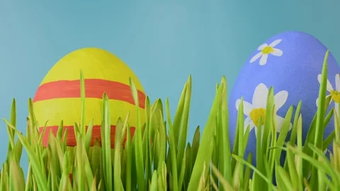 Three colored eggs on grass in easter holiday Stock Footage 122845878