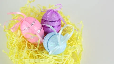 Three colored eggs lie in the nest on a white background with copyspace view Stock Footage 174708016