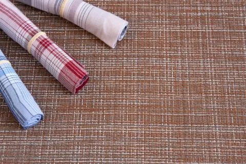 Three colored handkerchiefs lie in the corner. Stock Photos