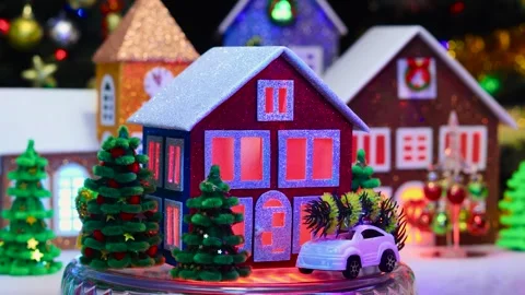 A three-colored house surrounded by green trees and cars rotates Video stock 293427690