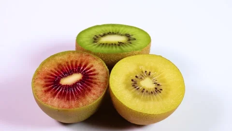 Three colored kiwi fruit rotating Stock Footage 310864949