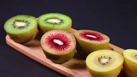 Three colored kiwi fruit rotating Stock-Footage 310864950