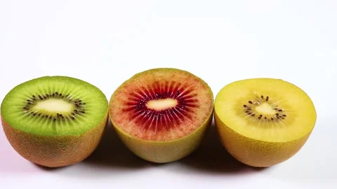 Three colored kiwi fruit rotating Video stock 311292053