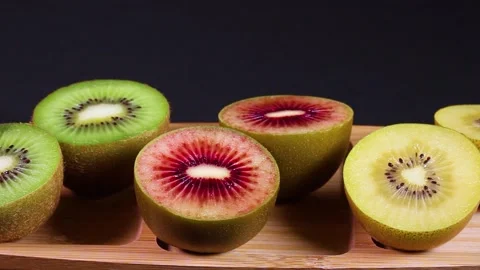 Three colored kiwi fruit rotating Stock Footage 311292063