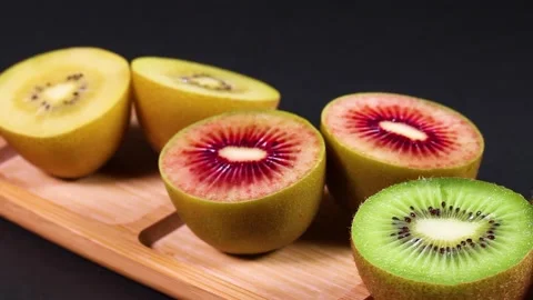 Three colored kiwi fruit rotating Stock Footage 311741668