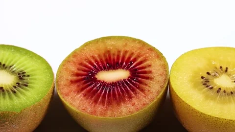 Three colored kiwi fruit rotating Video stock 311741669