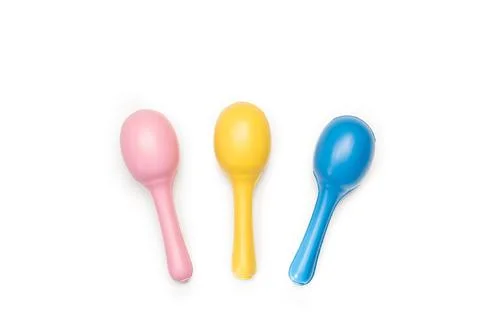 Three colored maracas on a white background with copy space Stock Photos