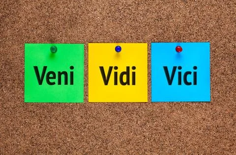 Three colored notes on corkboard with words Veni, vidi, vici Stock Photos