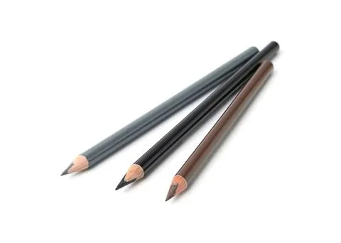 Three colored pencils lying on a white background Stock Photos