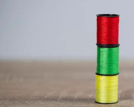 Three colored thread stand on the table. Foto stock