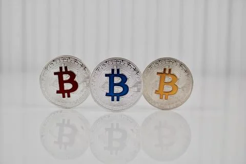 Three colorful bitcoins Stock Photos