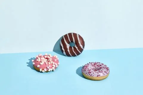 Three Colorful donuts on a blue background Stock Photos