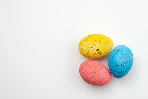 Three colorful eggs on a white background closeup. Easter background, copyspa Stock Photos