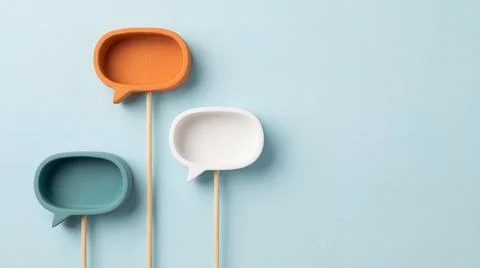 Three colorful empty ceramic speech bubbles on sticks against light blue ba.. Stock Illustration
