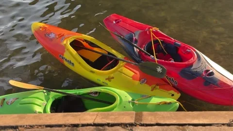 Three Colorful Kayaks Floating by the Rhine River Shore Stock Footage 345244997