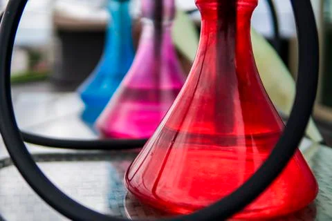 Three colors hookahs on table in hookah lounge in a day. Stock Photos