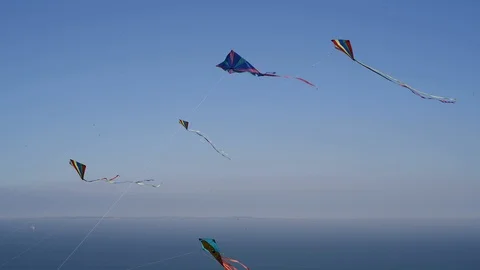 Three colourful kites in the wind Stock Footage 89622534