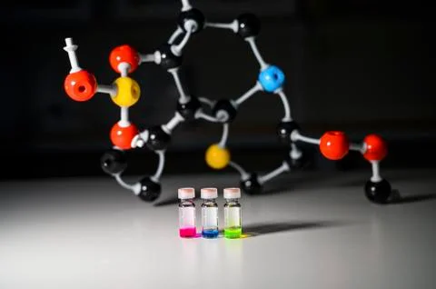 Three colourful solution in different LCMS glass vial on a white bench with m Stock Photos