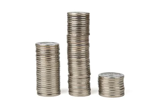 Three columns of different heights from coins of different denominations Stock Photos