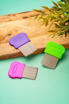 Three combs for lice removing on green background Stockfoto's