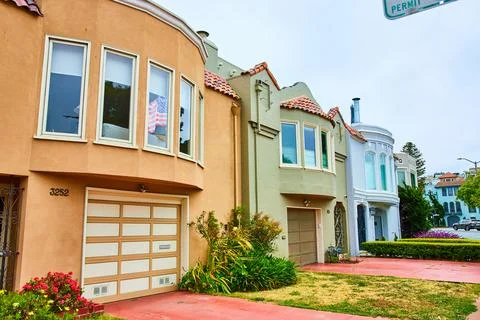 Three compact side by side houses with red sidewalks and driveways 스톡 사진