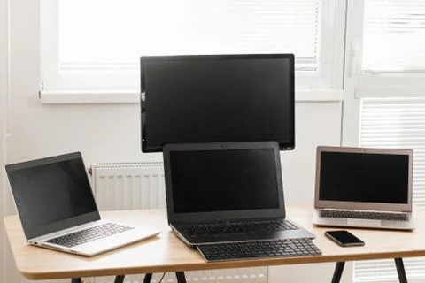 Three computers are on the desk. Home office concept. Video makers work place Stock Photos