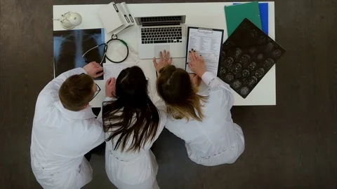 Three concentrated doctors using laptop in the office Vidéo 71622186