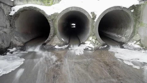 Three concrete drainage pipes that remove melted snow and ice, timelapse. Stock Footage 149239951