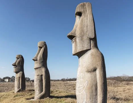 Three Concrete statues in a open field Stock Photos