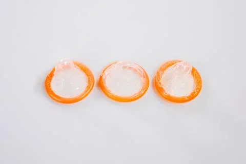 Three condom on a white background Stock Photos