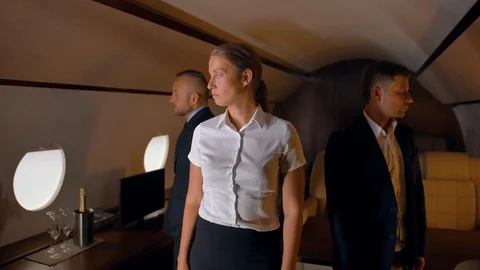 Three confident businesspeople inside of private jet Stock Footage 114171187